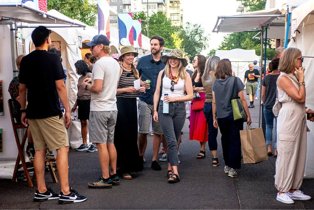 Photo of a crowd walking by emerging artist booths at the Cherry Creek Arts Festival